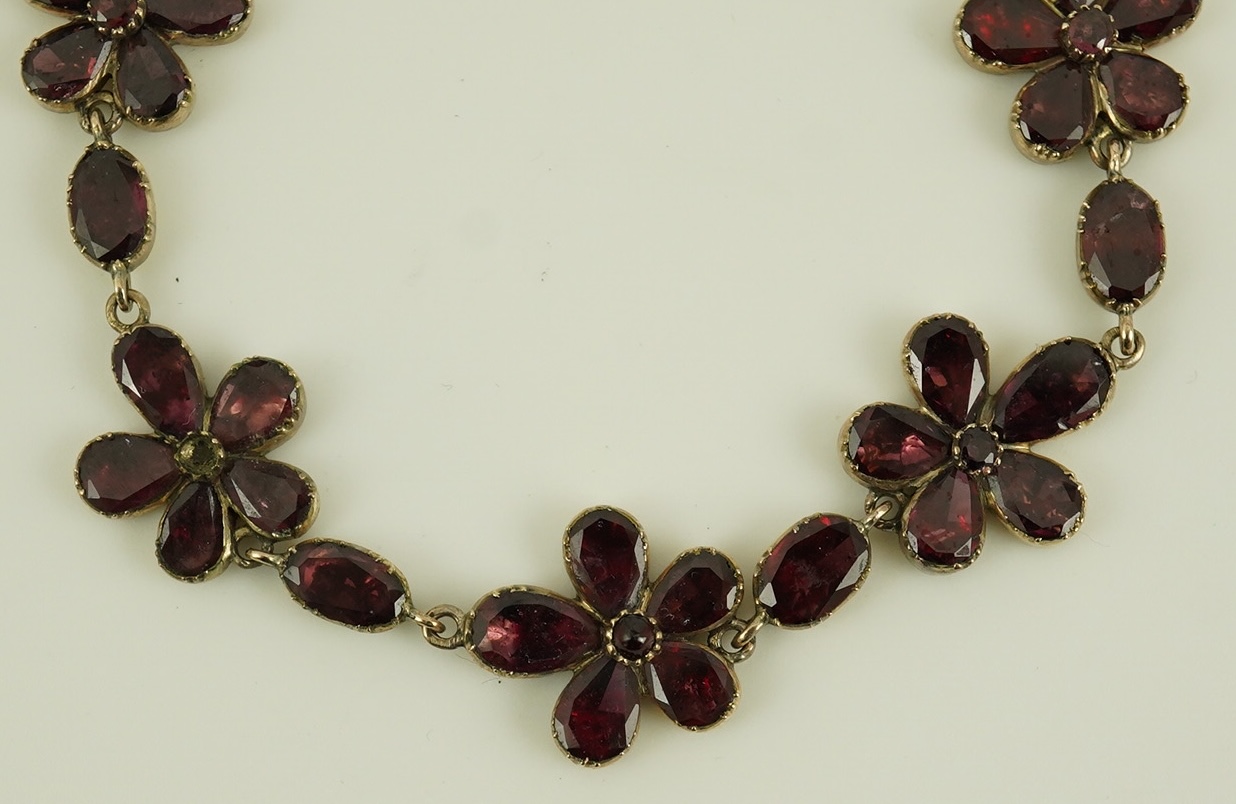 An early Victorian gold and foil backed garnet cluster set bracelet